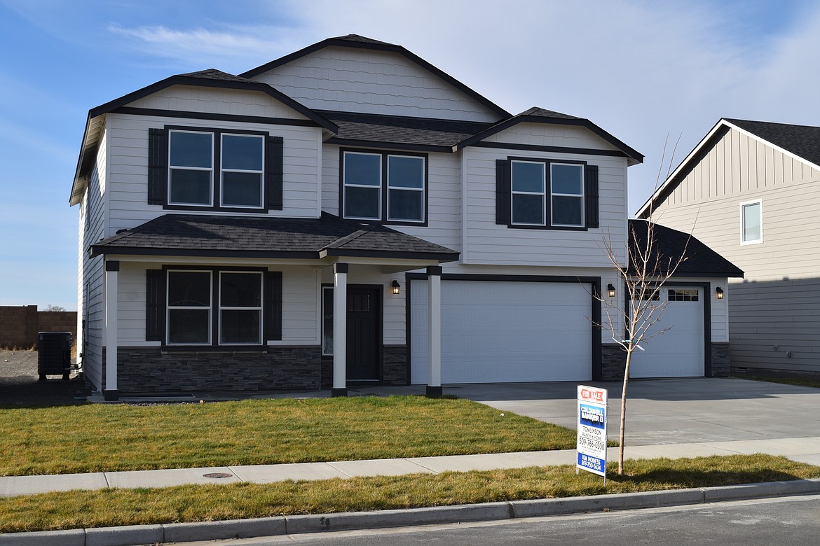 A newly built home is shown for sale on Doumit Drive in Moses Lake. According to data released by the Northwest Multiple Listing Service, home sales statewide dipped in October.