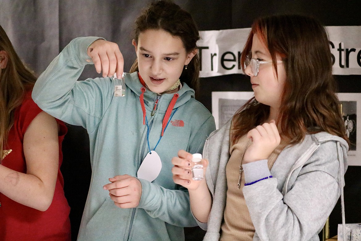 From left, fifth graders Dior Work and Colbie Tullis inspect water bugs at Idaho live history day on Wednesday at Fernan STEM Academy. HANNAH NEFF/Press