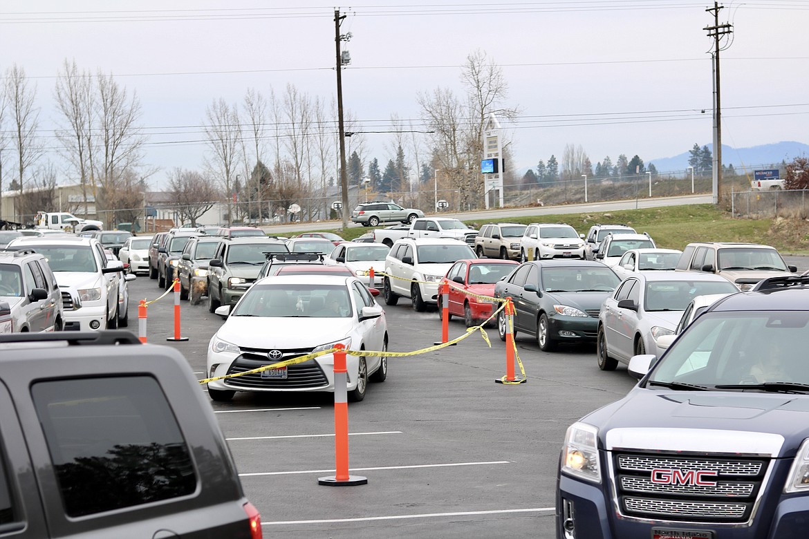 Hundreds of cars filed through Heart of the City Church in Coeur d'Alene on Thursday to pick up frozen turkeys and gift cards through Turkeys and More. The group donated 1,800 turkeys to families in need. HANNAH NEFF/Press