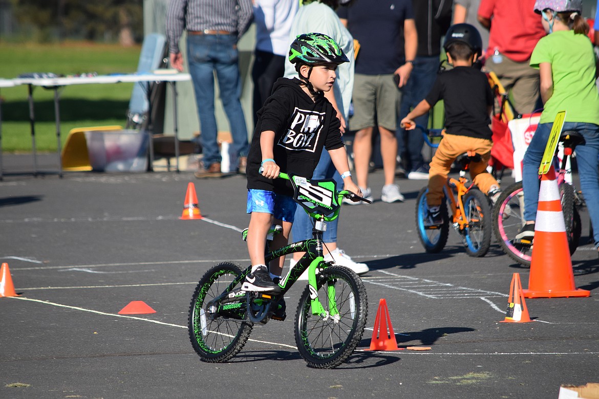 A bicyclist circles the course during the bike rodeo sponsored by the Moses Lake Kiwanis in September.