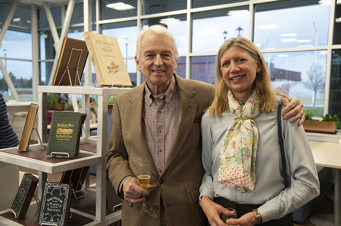 Whitefish residents Nick and Karen Chickering are pictured at a reception  Nov. 16 next to a display of rare western literature, part of a larger collection which they recently donated to the Broussard Family Library and Learning Commons at Flathead Valley Community College. - photo by Sally Johnson, FVCC graphic design specialist