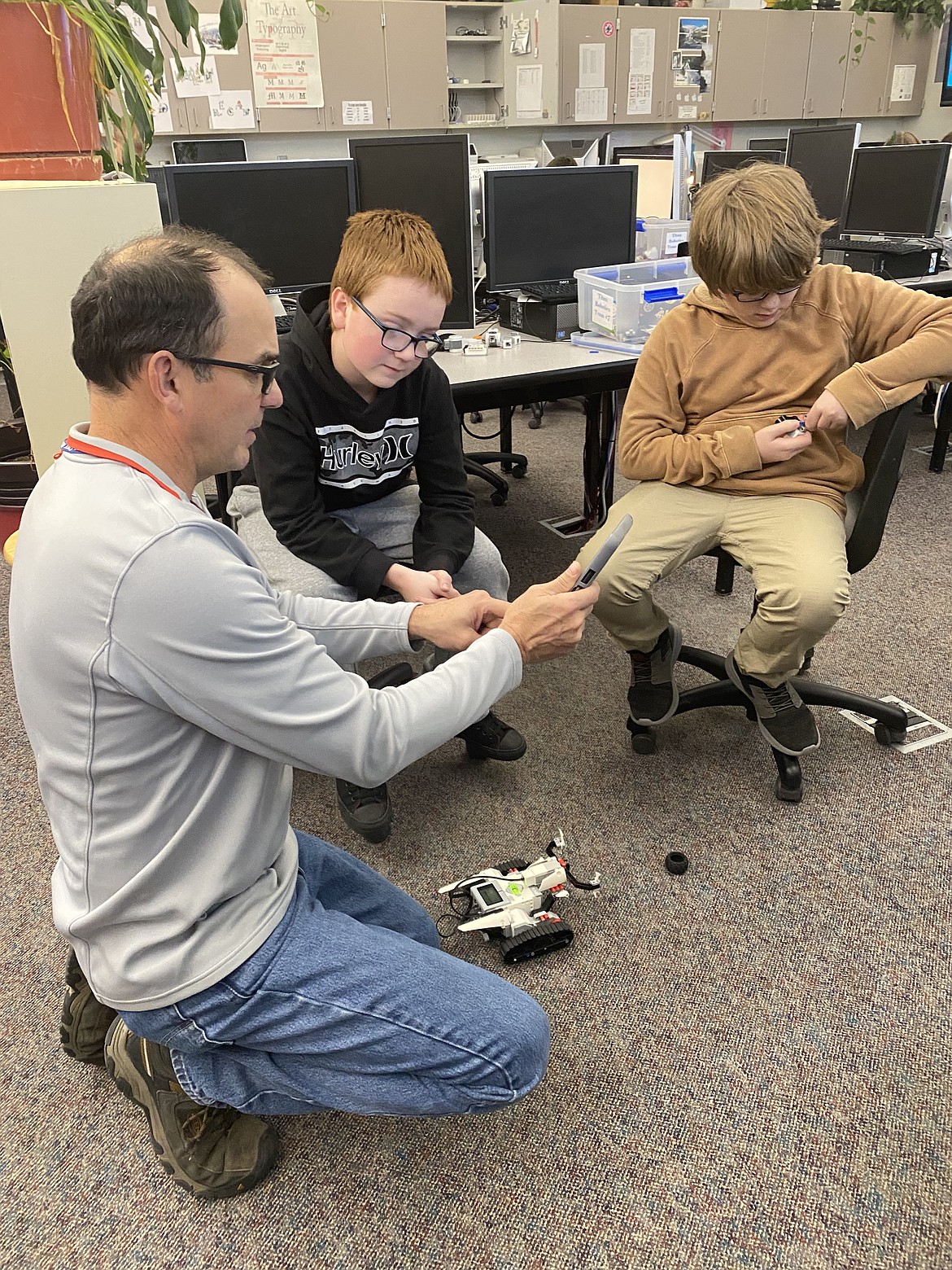 Friday at River City Middle School, sixth grade teacher Kevin Hauck goes over the technicalities of a robotics project with students, from left: Dylan Rounsville, 12 and Ethan Palmer, 11.