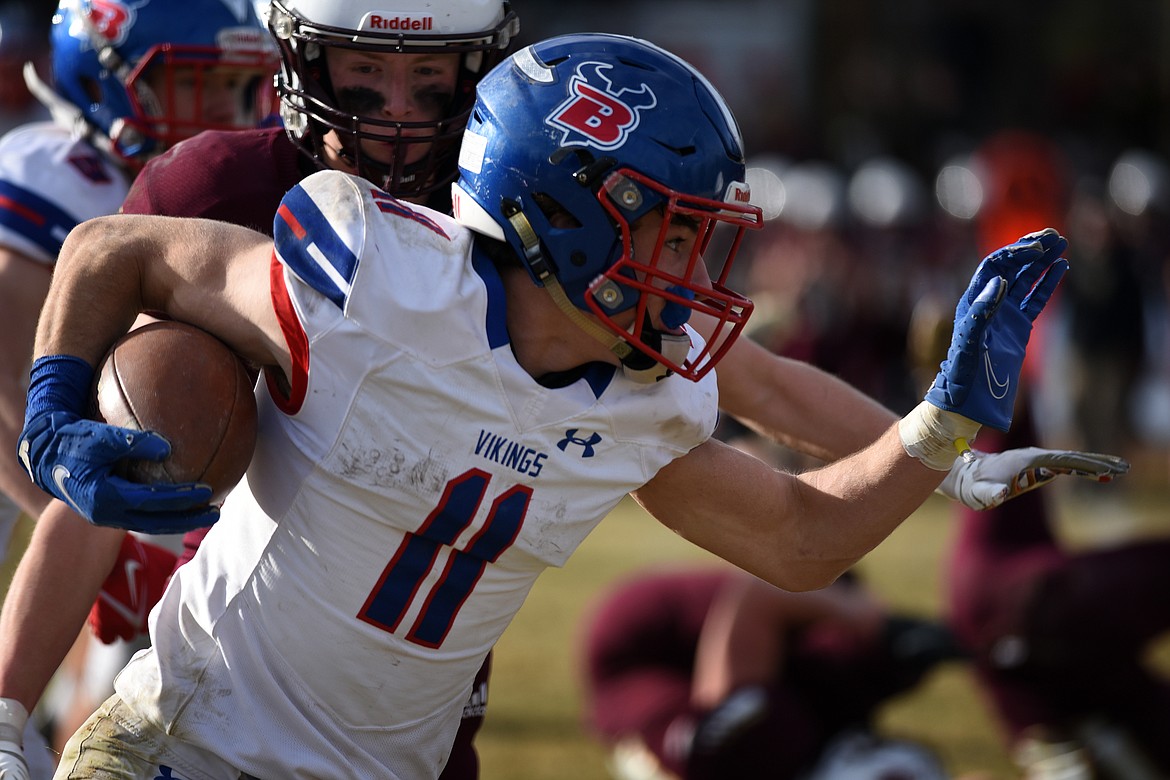 Bigfork’s George Bucklin looks to hold off the Florence defense during a third-quarter run in  the Class B football state title game Saturday, Nov. 20. (Jeremy Weber/Daily Inter Lake)