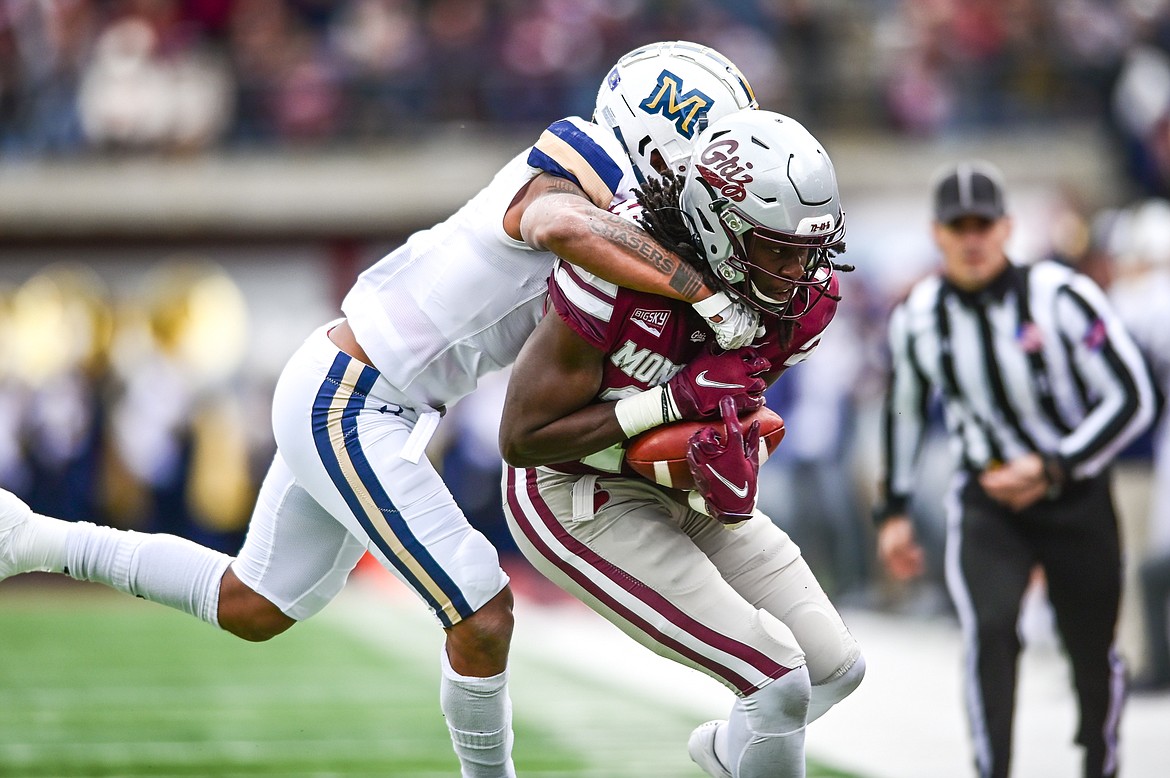 Montana wide receiver Samuel Akem (18) is brought down by Montana State defensive back Eric Zambrano (1) during the 120th Brawl of the Wild at Washington-Grizzly Stadium on Saturday, Nov. 20. (Casey Kreider/Daily Inter Lake)