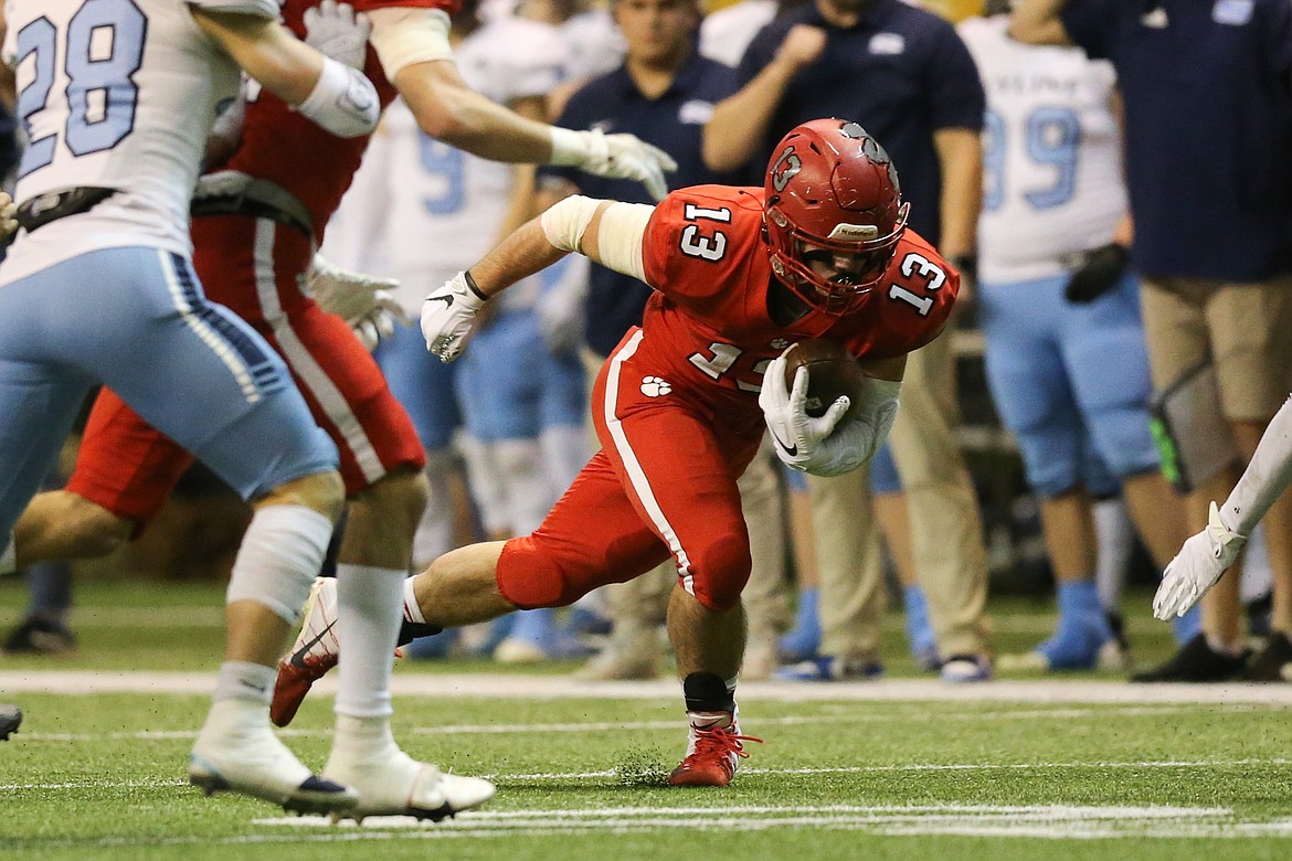 Senior Gerrit Cox carries the ball on Friday at the Kibbie Dome.