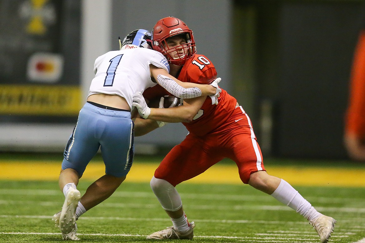 Junior Arie VanDenBerg tries to fight through a tackle from a Skyline defender during Friday's 4A state championship game at the Kibbie Dome.