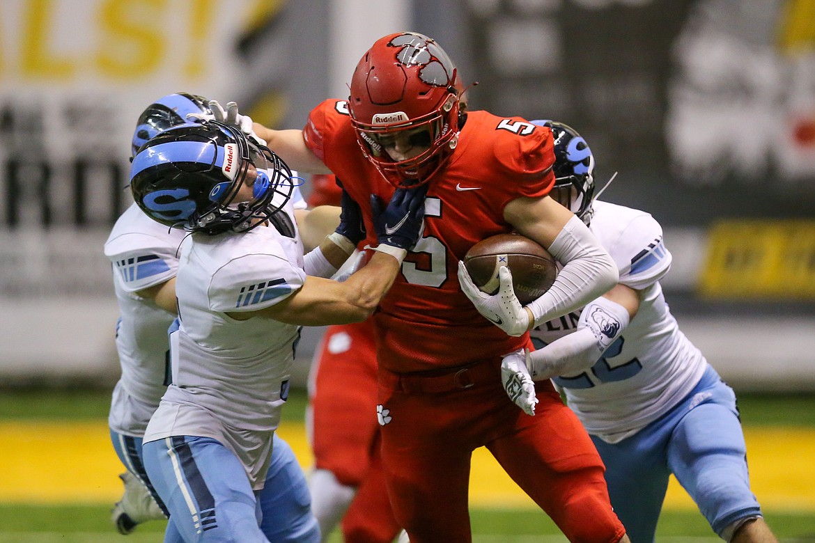 Sophomore wide receiver Max Frank, who played with a broken leg, stiff arms a Skyline defender Friday at the Kibbie Dome.