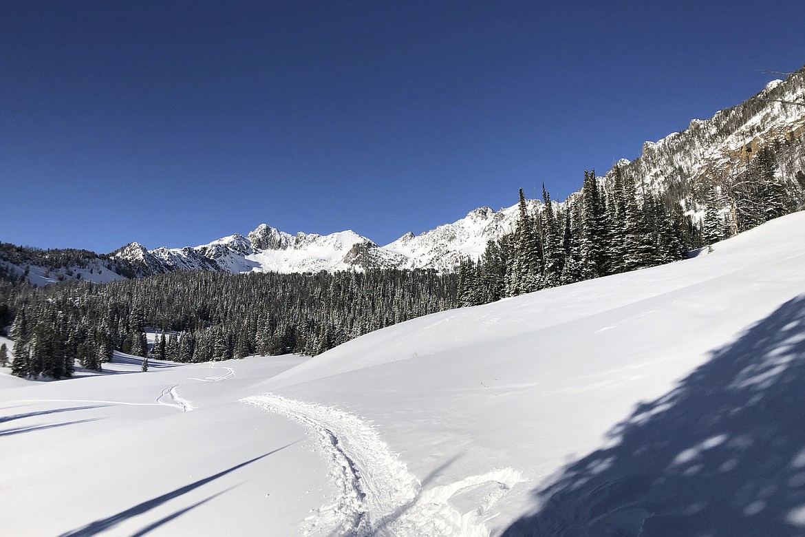 Shown is Lone Peak, which rises above the resort community of Big Sky, Montana, on Jan. 31, 2021. A program in Big Sky that offers cash incentives for homeowners to rent to local workers, rather than offering short-term rentals, is improving the housing availability in Big Sky. In the first three months of the Rent Local program created by the Big Sky Community Housing Trust, it converted 21 homes to long-term rentals and housed 58 local workers. (AP Photo/Matthew Brown)