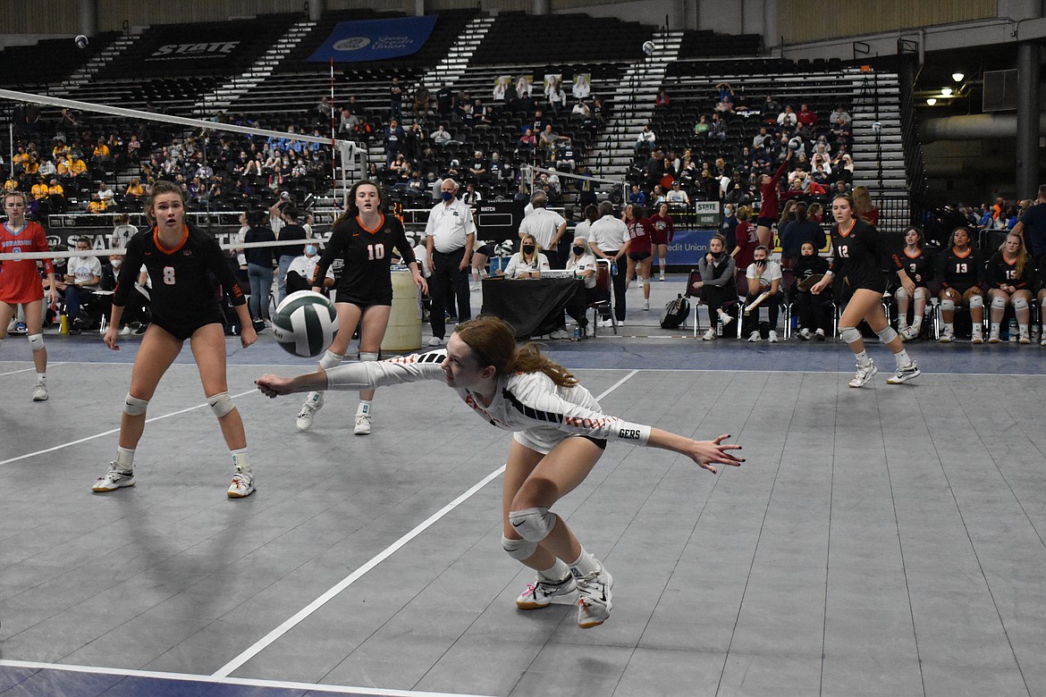 Halee Moore (1) dives to hit the ball during the matchup Friday against Mark Morris at the Washington Interscholastic Activities Association (WIAA) State Championships 2A volleyball tournament.