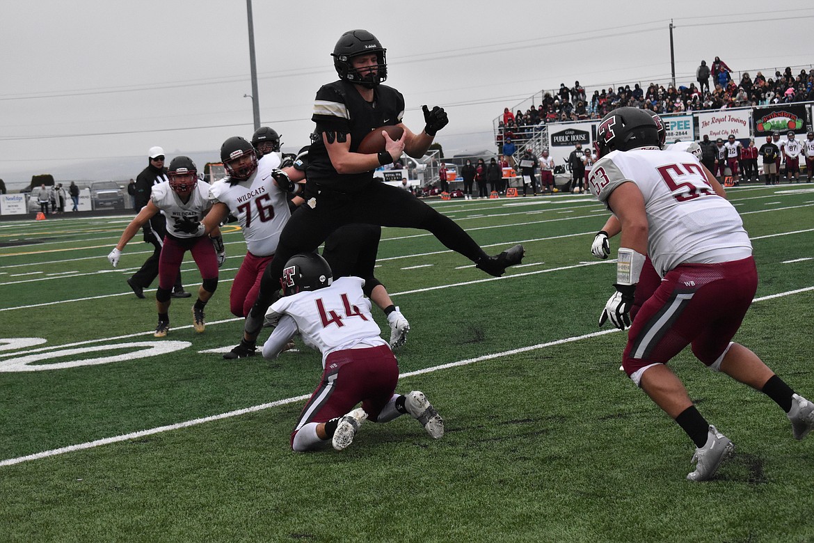 Royal senior Derek Bergeson (6) rushes past multiple Toppenish players, even jumping one during the state quarterfinals Saturday.