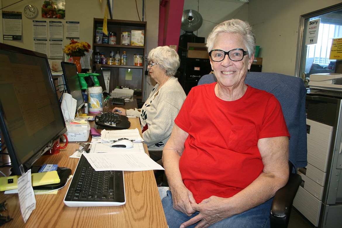 Volunteer Karen Zerby sits at her desk at the Moses Lake Food Bank.