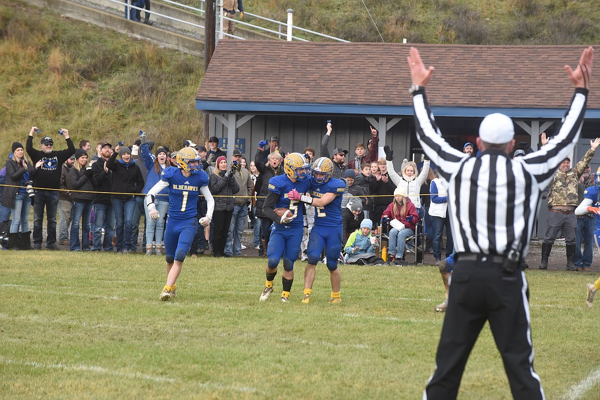 Thompson Falls junior quarterback Elijah Ratliff (1) celebrates Nathan Schraeder’s fumble return for a touchdown with teammate Ryan Bucher (1) during last Saturday’s Montana 8-man title game. The Blue Hawks won 40-8. (Scott Shindledecker/Valley Press)