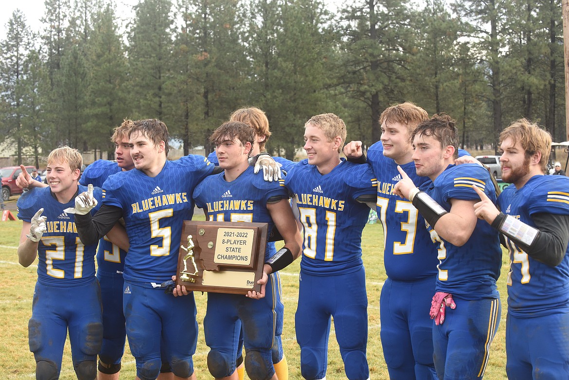 Senior class members of the 2021 Thompson Falls football celebrate with the state championship trophy last Saturday. The Blue Hawks beat Flint Creek, 40-8. (Scott Shindledecker/Valley Press)