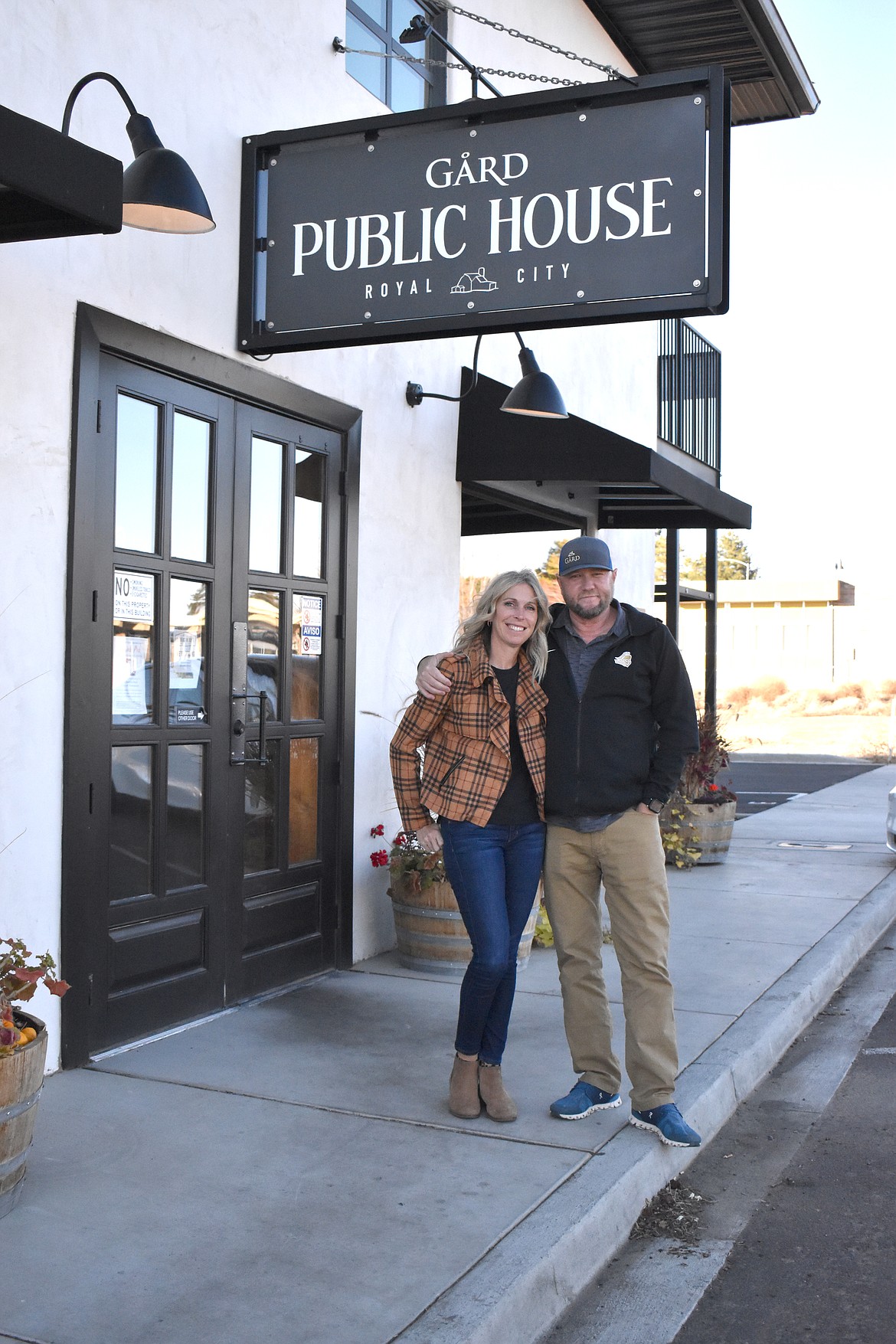 Lisa and Josh Lawrence stand outside their Gård Public House in Royal City.