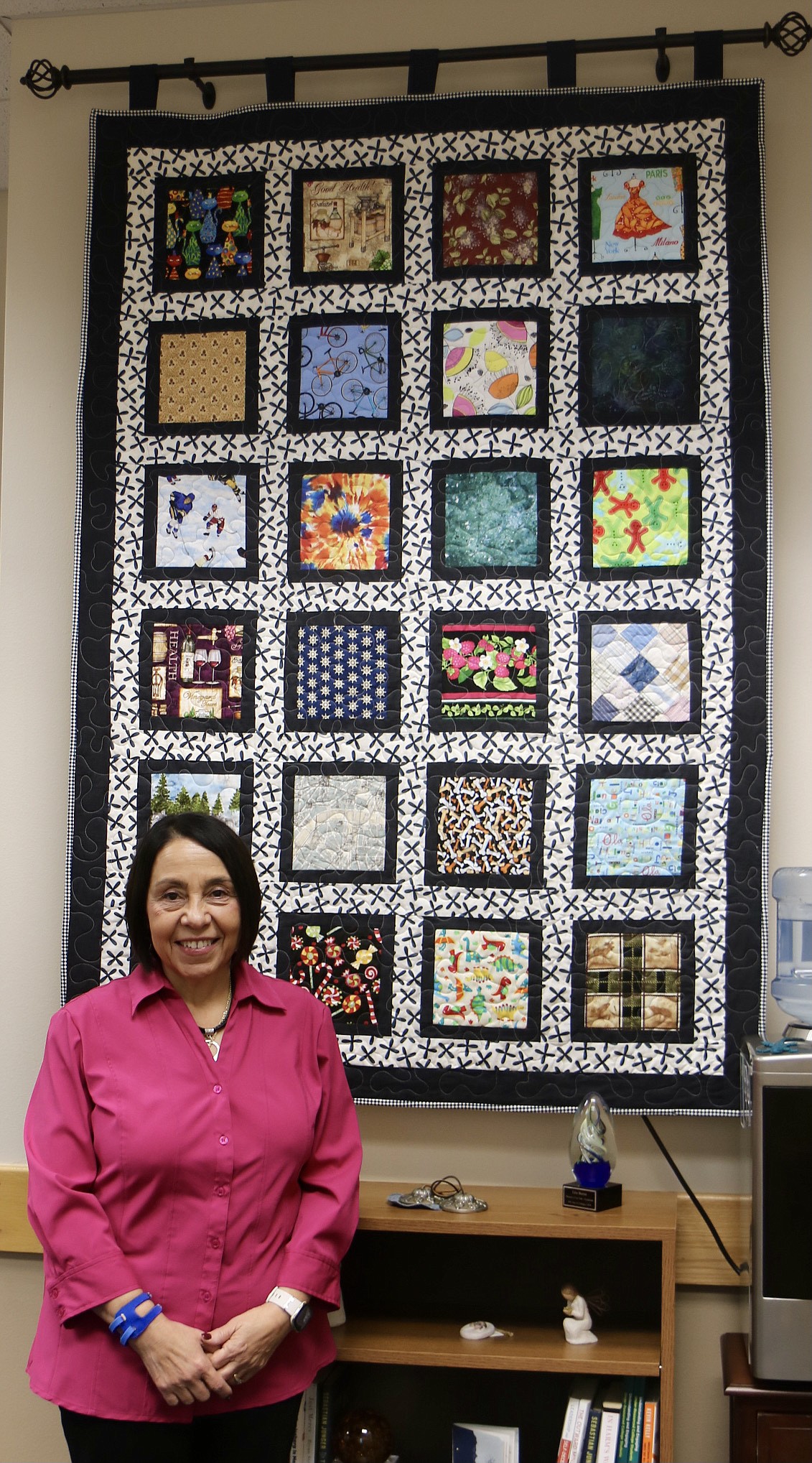Retiring Vice President of Instruction Lita Burns stands next to a quilt, gifted to her by her colleagues when she transitioned to her current position from her position as Dean of Health Professionals and Nursing which she took on in 2001. HANNAH NEFF/Press