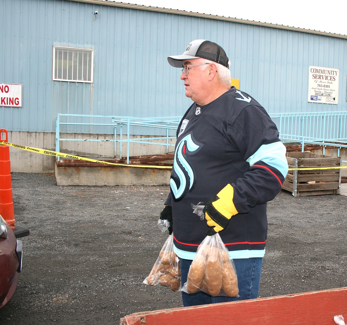 Rich Howard waits to give potatoes during the Thanksgiving distribution drive-thru at the Moses Lake Food Bank Monday.