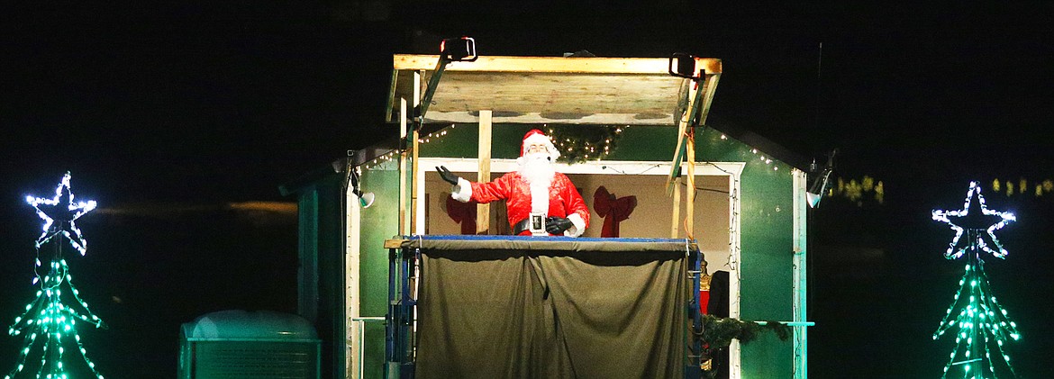 Santa Claus greets visitors at the North Pole during a cruise across Lake Coeur d’Alene from The Coeur d’Alene Resort Tuesday night. This season marks the Resort’s Holiday Light Show's 35th year.