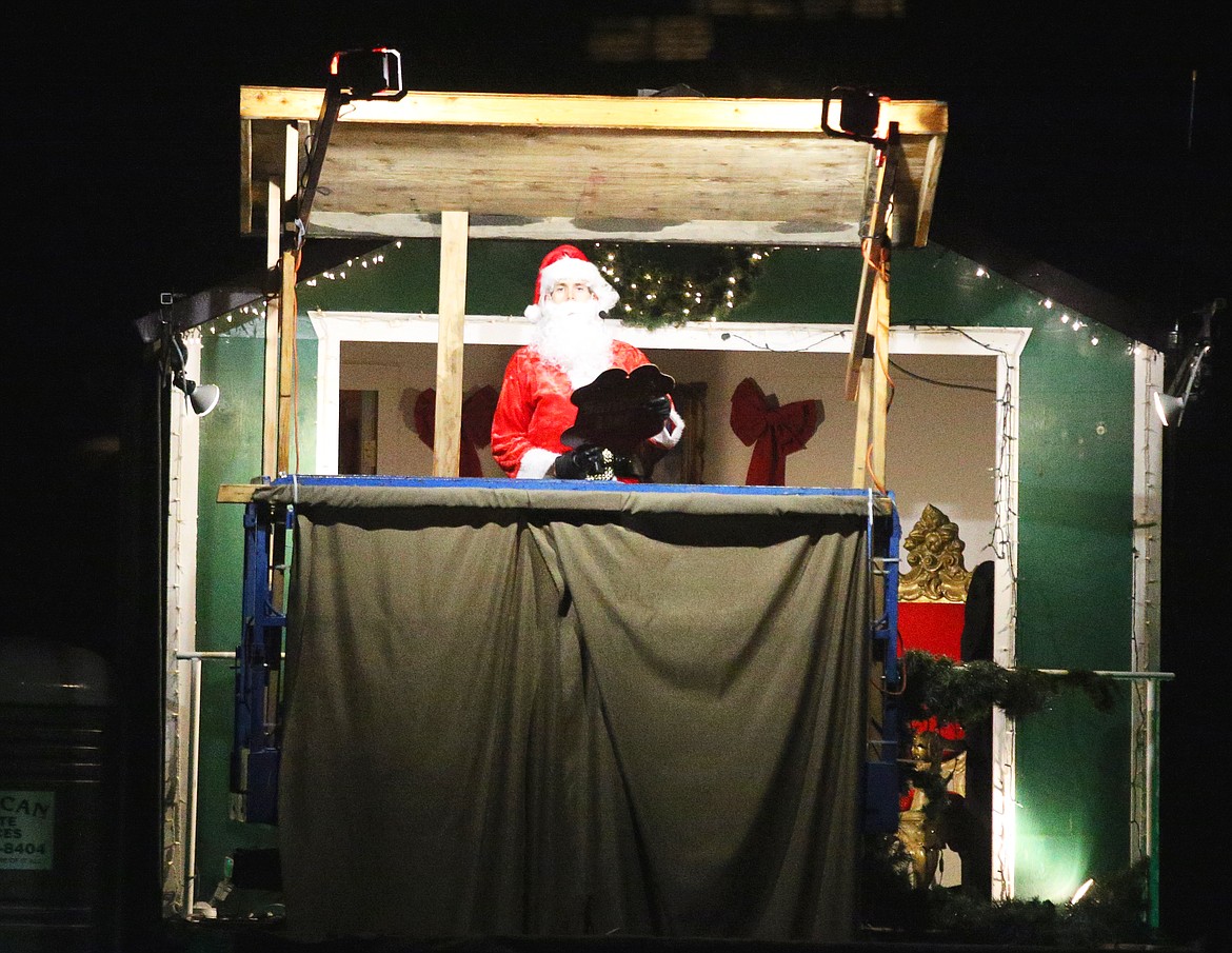 Santa Claus reads the names of children on the good list at the North Pole during a cruise across Lake Coeur d’Alene from The Coeur d’Alene Resort Tuesday night. The Resort’s Holiday Light Show is in its 35th year.