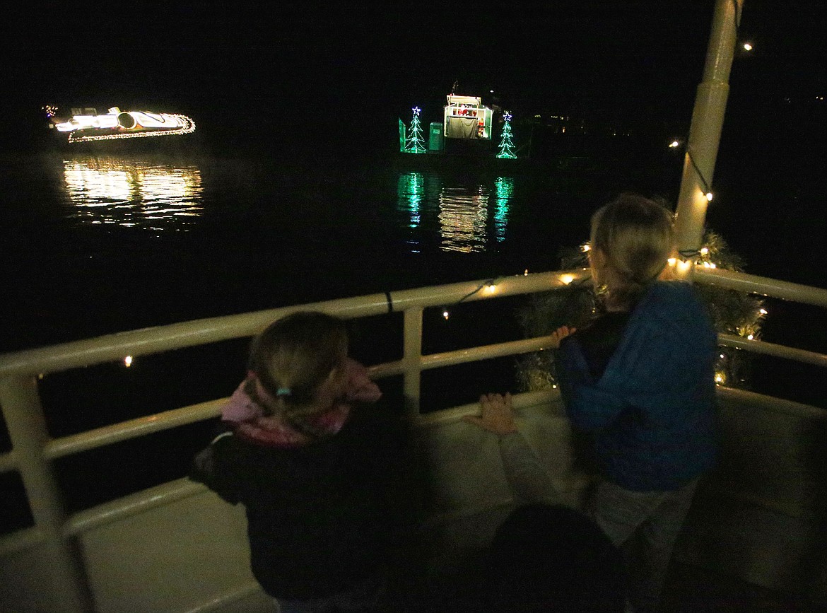 Kids look toward Santa Claus's workshop on their Journey to the North Pole Cruise across from The Coeur d'Alene Resort on Tuesday night.