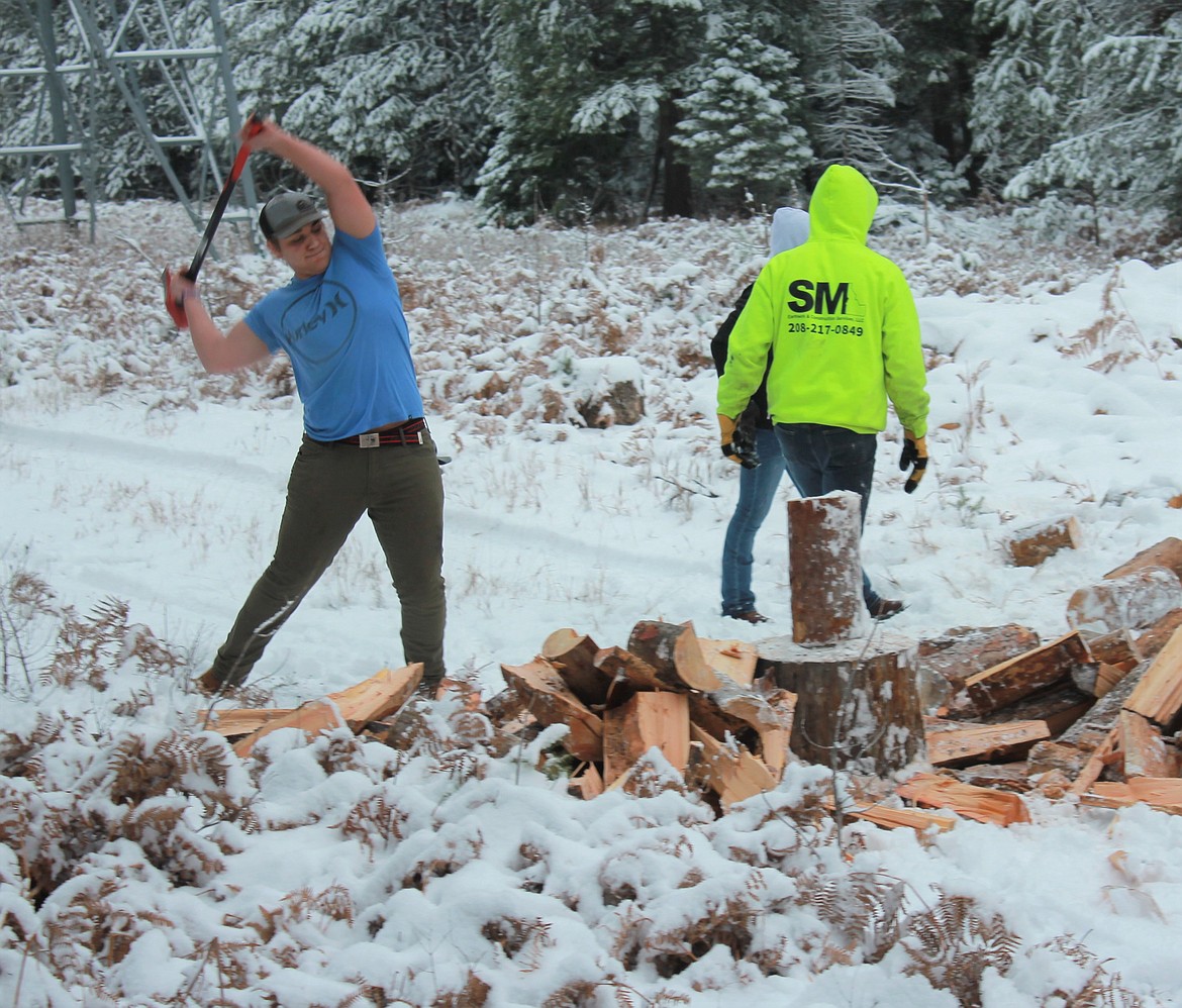 (left) Jackson Rickter and other wrestlers splitting wood for the wrestling team's annual firewood fundraiser.