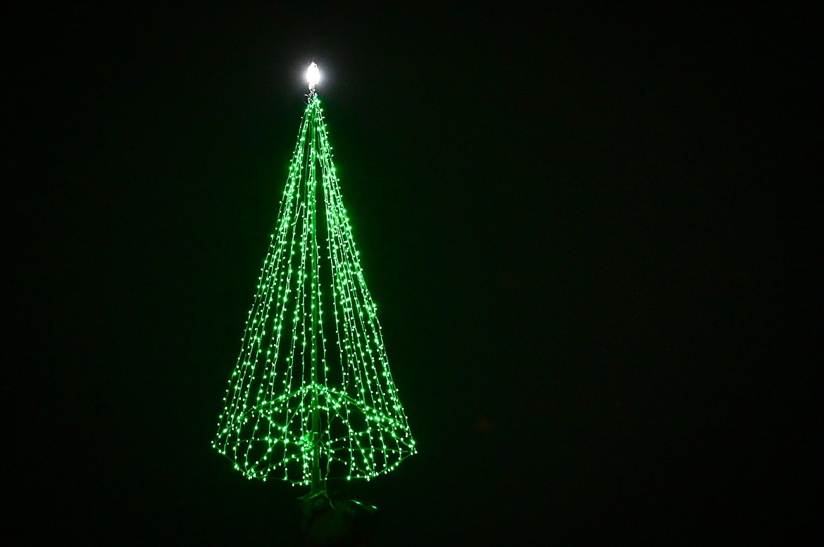 The Evergreen Christmas tree is lit and suspended from a crane outside Harmon Crane & Rigging on Tuesday, Nov. 23. (Casey Kreider/Daily Inter Lake)