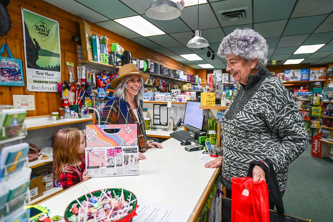 Myrella Harsh, right, chats with Katie Morrison and her daughter Kinley after making a purchase at Imagination Station in Kalispell on Wednesday, Nov. 24. (Casey Kreider/Daily Inter Lake)