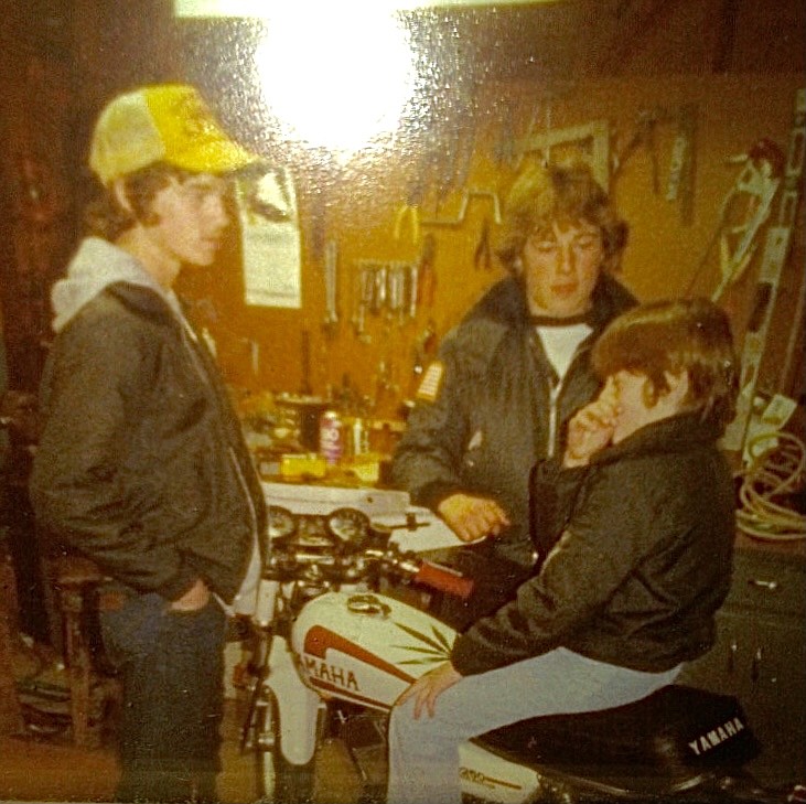 Lee Gibson, left, his brothers Eric, center, and Jim, right, pose with Lee's first motorcycle in 1981 — a 1977 Yamaha RD350. Photo courtesy Lee Gibson.