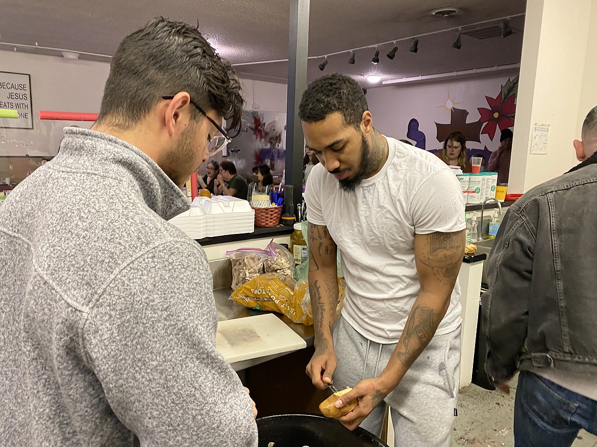 The Altar Church volunteers Erik Gonzalez, left, and Jawaun Anderson help prepare the next batch of mashed potatoes. (MADISON HARDY/Press)