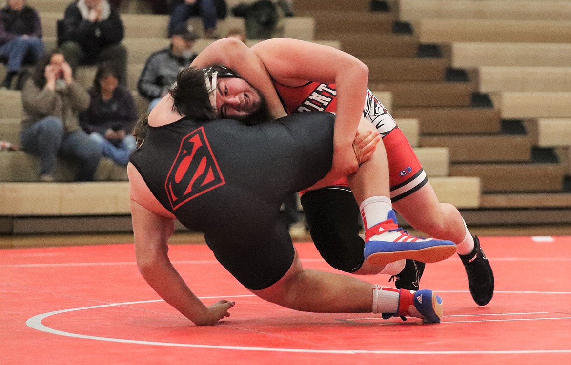 Greg Belgarde (red) takes down his opponent on Wednesday.