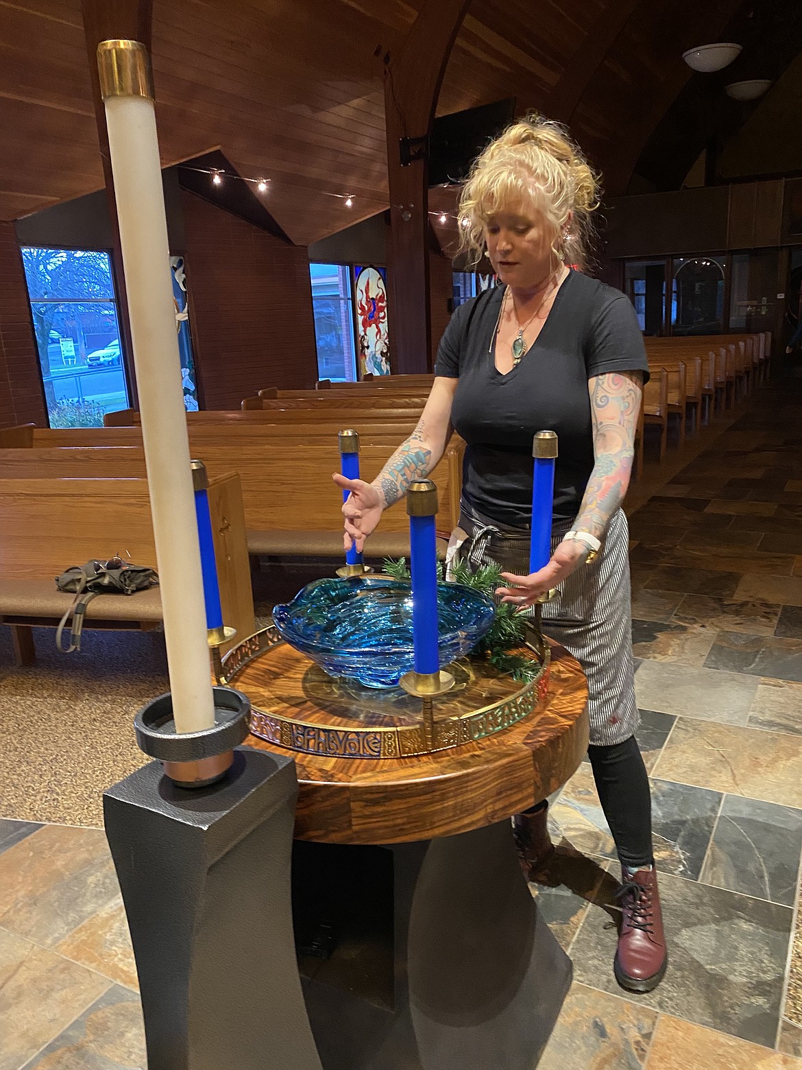 Local artist Shannon Erwin adds the touch of some greenery to the hand-crafted Advent ring created by artist Tom Husby for Trinity Lutheran Church.