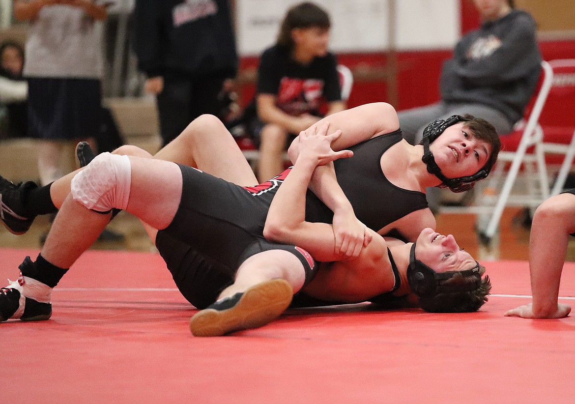 Matthew Clifton (top) pins Robert Newsom during Wednesday's scrimmage at Les Rogers Court.
