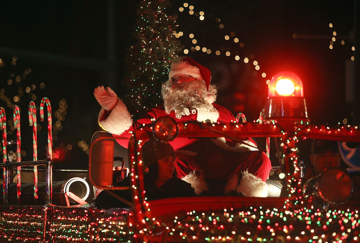 Santa waves during the 29th annual Lighting Ceremony Parade Friday night on Sherman Avenue.