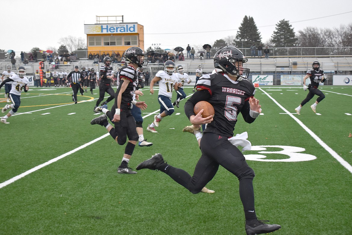 Almira/Coulee-Hartline High School senior Dane Isaak (5) rushes down the field to score the first touchdown against Naselle High School, with a 53-yard run in the first 15 seconds of the game.