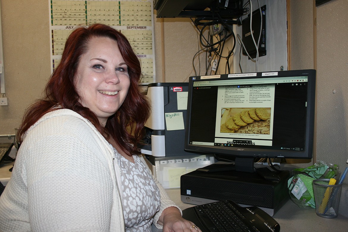 Moses Lake Grocery Outlet co-owner Kris Emerson sits at her computer.