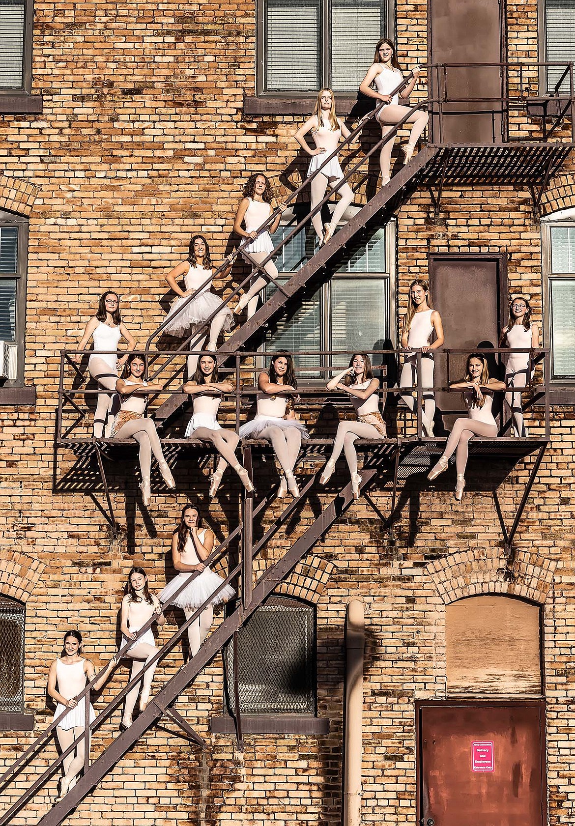 The Noble Dance Performing Company includes upper stairs from left, Morgan Friar, Ella Gerbozy, Rita Henshaw, Reghan Donahue; middle row, Merrel Cooley, Cecilia Molter, Ananda Tadje-Soifer, Bella Jepsen, Mia Gannon, Karissa Jepsen, Lucia Ghekiere, Taylor McCracken; lower stairs, Abby Hepworth, Tove Davies and Eden Rodriguez. Not pictured are Brie Treat and Maggie Giffin. (Photo courtesy Wayne Murphy of JMK Photography)