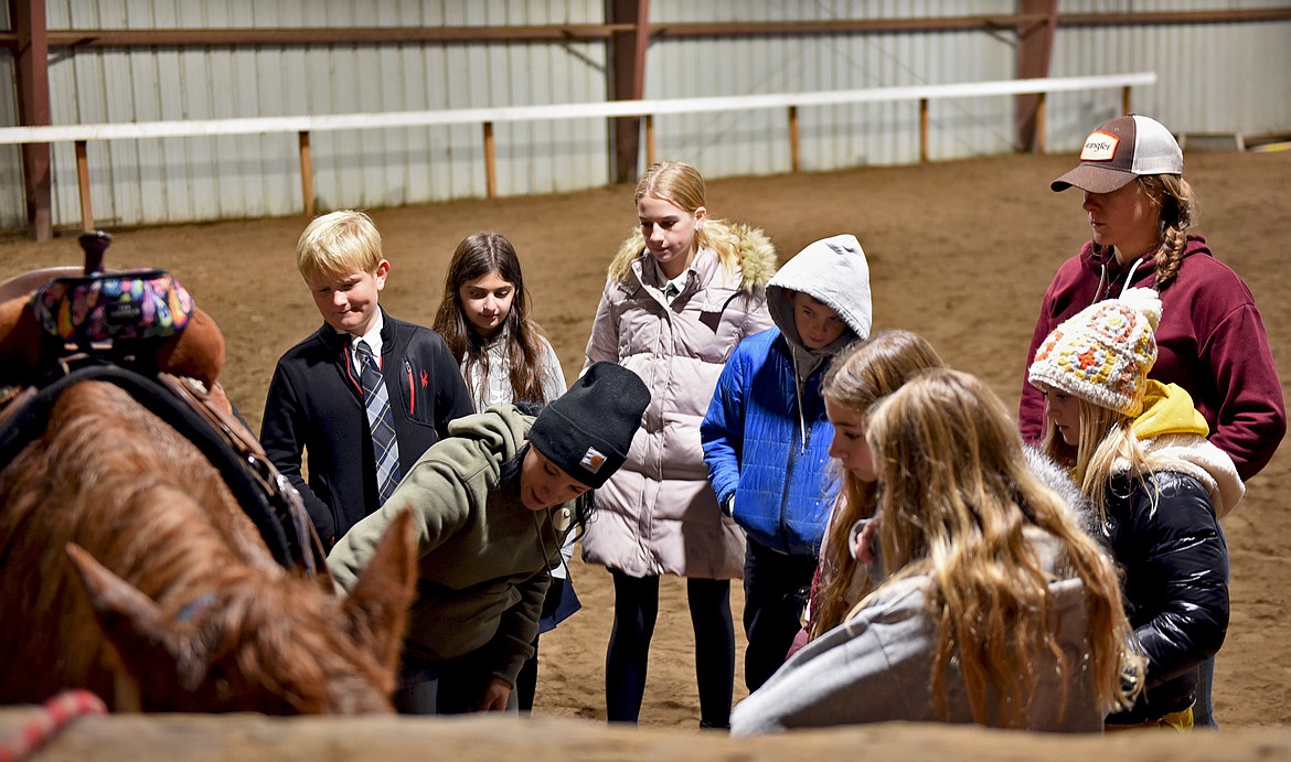Lost Creek Ranch owner and instructor Chanel Olson teaches Whitefish Christian Academy students how to tack up a horse as part of the school's Horsemanship Program on Friday, Nov. 12. (Whitney England/Whitefish Pilot)