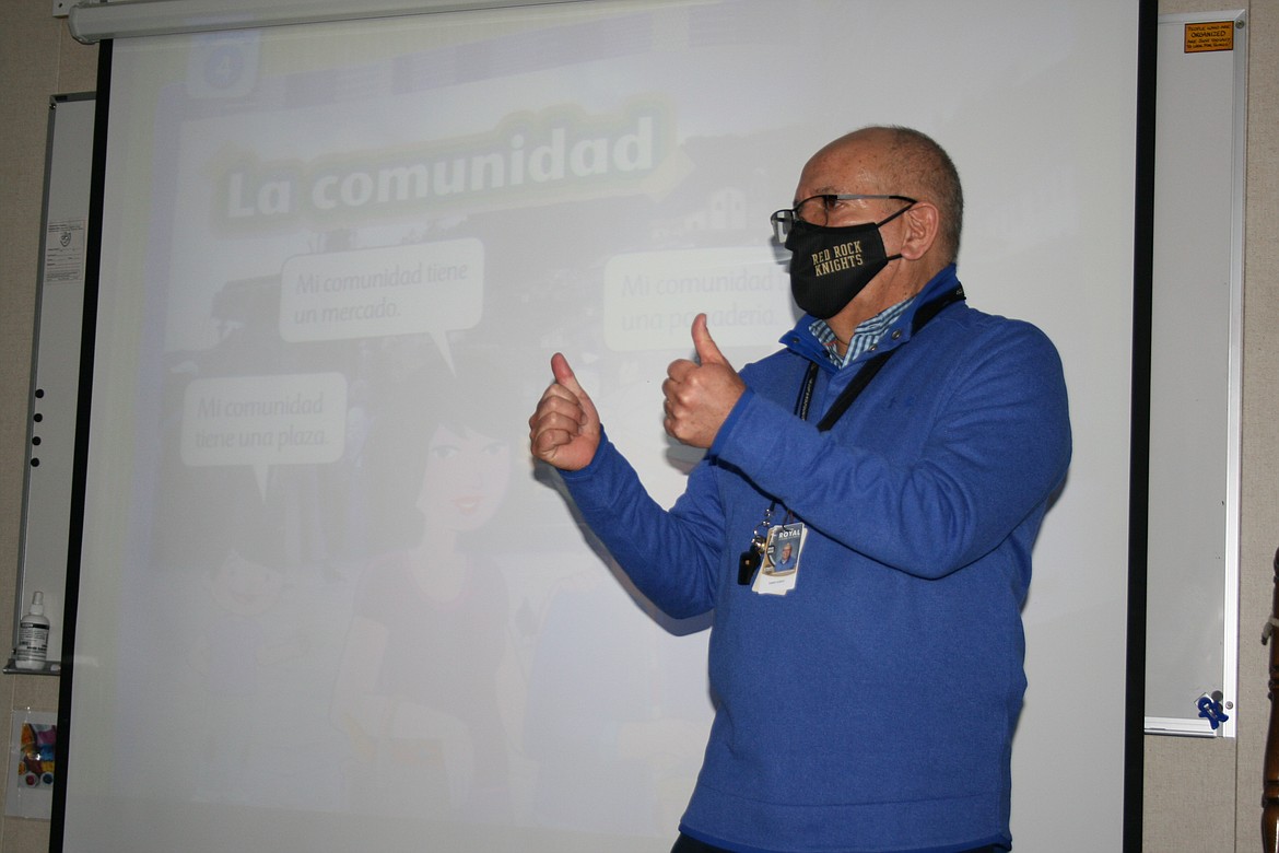 Red Rock Elementary School Spanish teacher Mario Godoy Gonzalez gives the thumbs up to his first grade class.