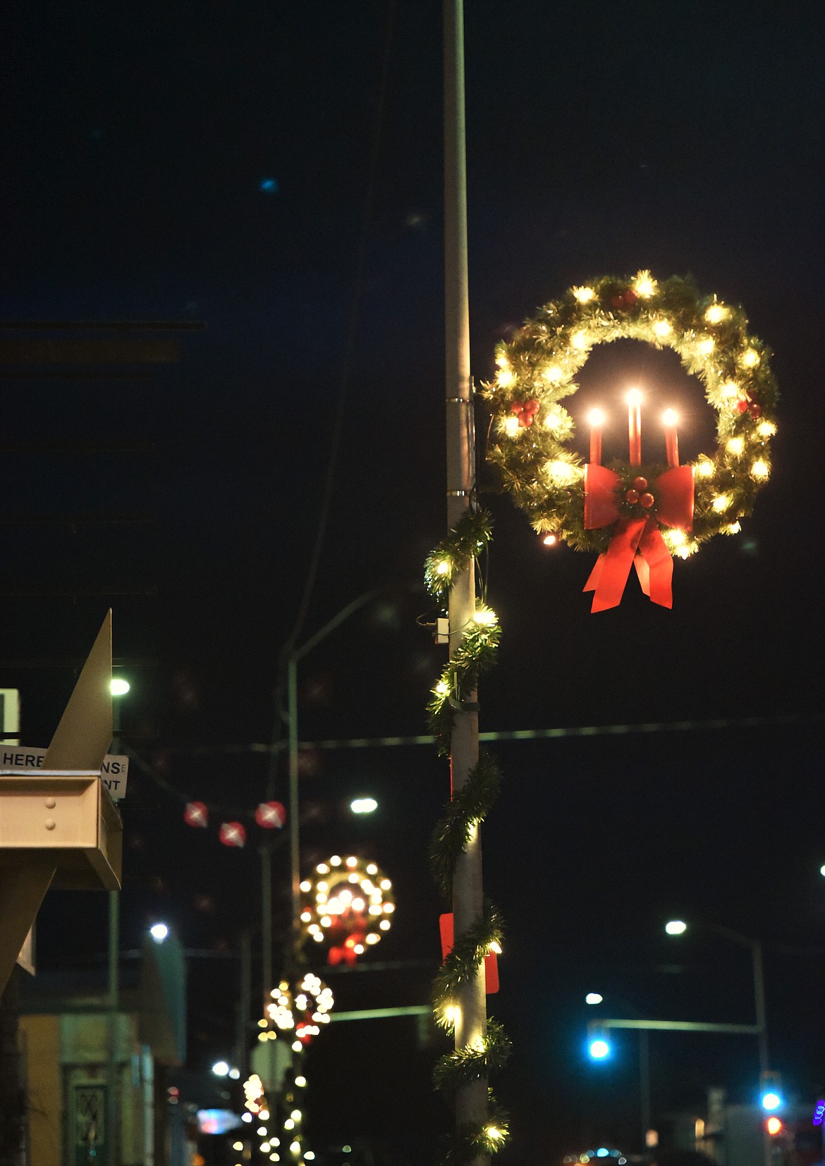 Brightly lit wreaths line First Avenue in downtown Polson. (Scot Heisel/Lake County Leader)