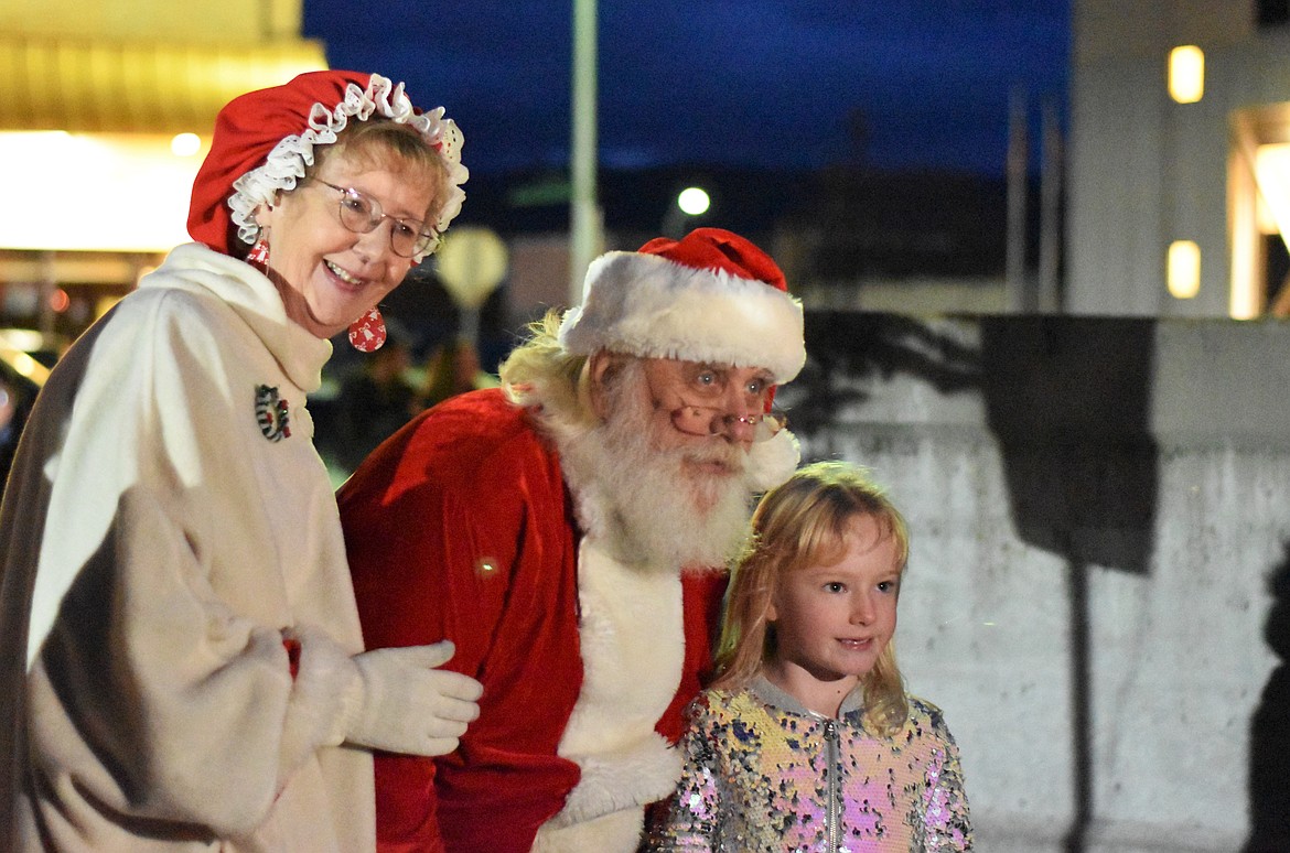 Mr. and Mrs. Claus pose for a photo with a young lady at the annual tree lighting Saturday night at the Lake County Courthouse. (Emily Lonnevik/Lake County Leader)