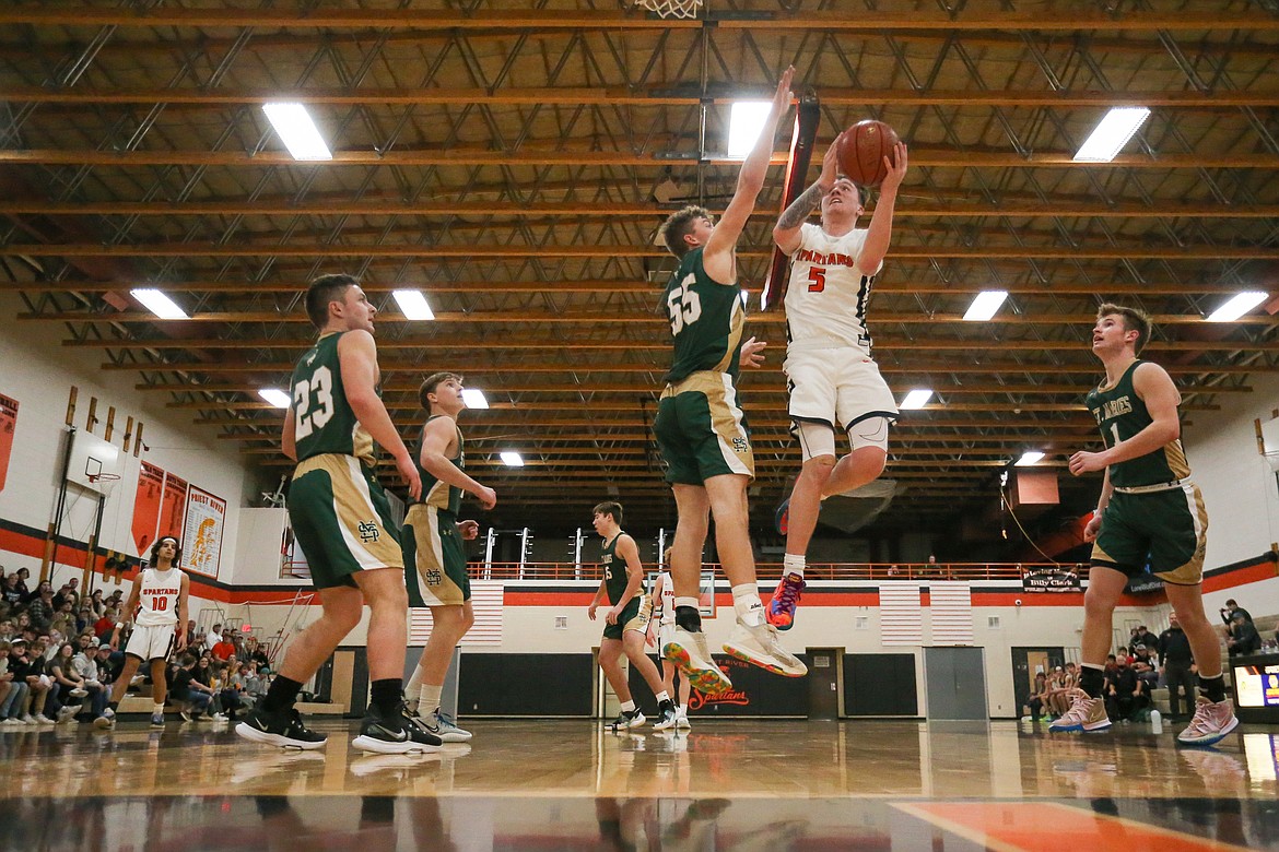 Trentyn Kreager attacks the basket and tries to convert a layup during Tuesday's game.