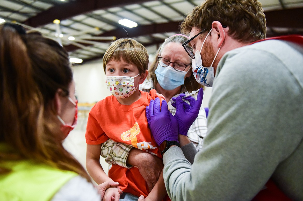 Ember Reed, 6, is administered a Pfizer Covid-19 vaccine with her grandmother and guardian Aggie (back) during a clinic for children ages 5-11 at the Flathead County Fairgrounds in Kalispell on Wednesday, Dec. 1. (Casey Kreider/Daily Inter Lake)