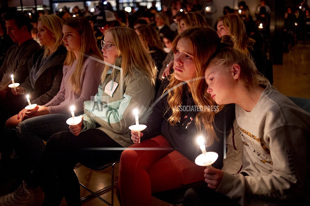 Emerson Miller, right, leans on her friend Joselyn's shoulder as they listen to Jessi Holt, pastor at LakePoint Community Church, during a prayer vigil at the church after the Oxford High School school shooting, Tuesday, Nov. 30, 2021, in Oxford, Mich. (Jake May/The Flint Journal via AP)