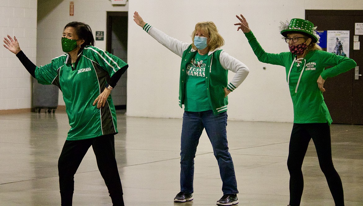From left, the Sarah Parshall, Christy Hainline and Mikki Stevens of the Red Hot Mamas dance during the trip meeting for their Ireland St. Patrick's Day tour in March. The group was invited to perform at Ireland’s St. Patrick’s Day Festival in 2020 and 2021 as well, but COVID-19 restrictions kept them from traveling. HANNAH NEFF/Press