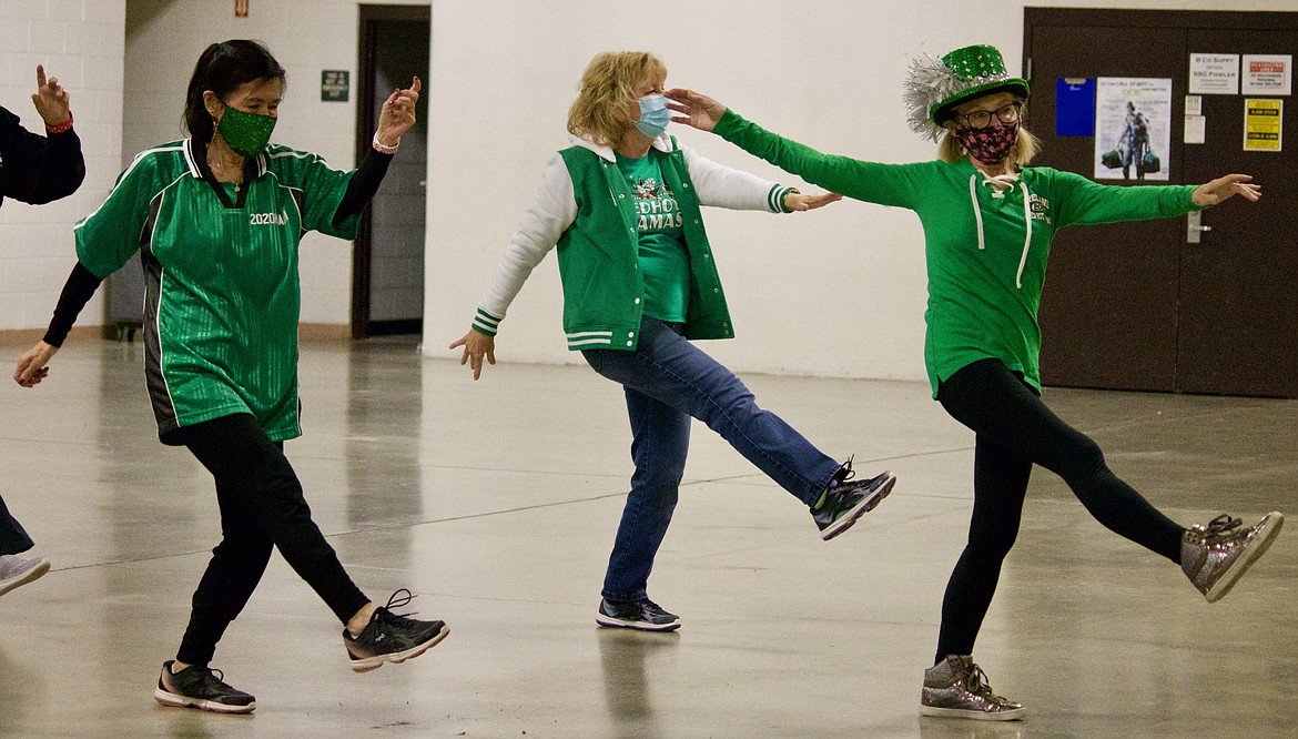 From left, Red Hot Mamas Sarah Parshall, Christy Hainline and Mikki Stevens dance at the group meeting on Tuesday at the Post Falls Armory. HANNAH NEFF/Press