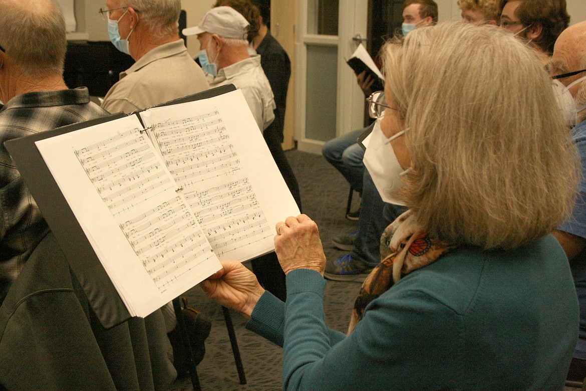 Regina Maag turns the page during rehearsal Sunday for the Quincy Valley Allied Arts Community Christmas Concert.