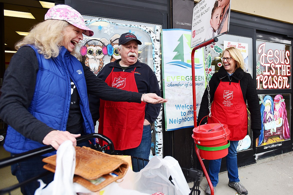 Gary and Luann Mahugh ring bells for the Salvation Army in front of the Super 1 Foods in Evergreen as a woman makes a donation on Thursday, Dec. 2. (Casey Kreider/Daily Inter Lake)