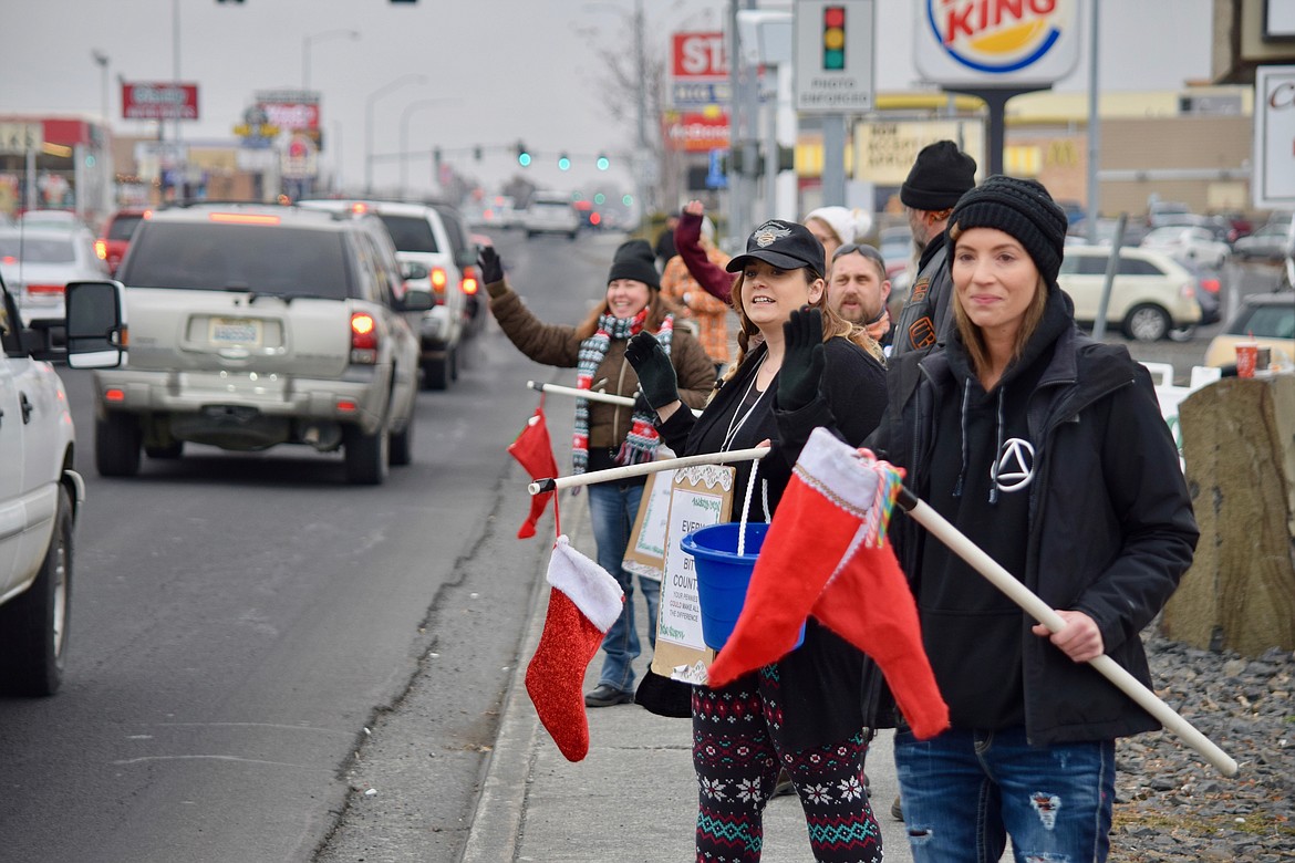 Members of the Unchained Brotherhood motorcycle club, family and friends solicit donations of toys and money for their toy drive in December 2018.