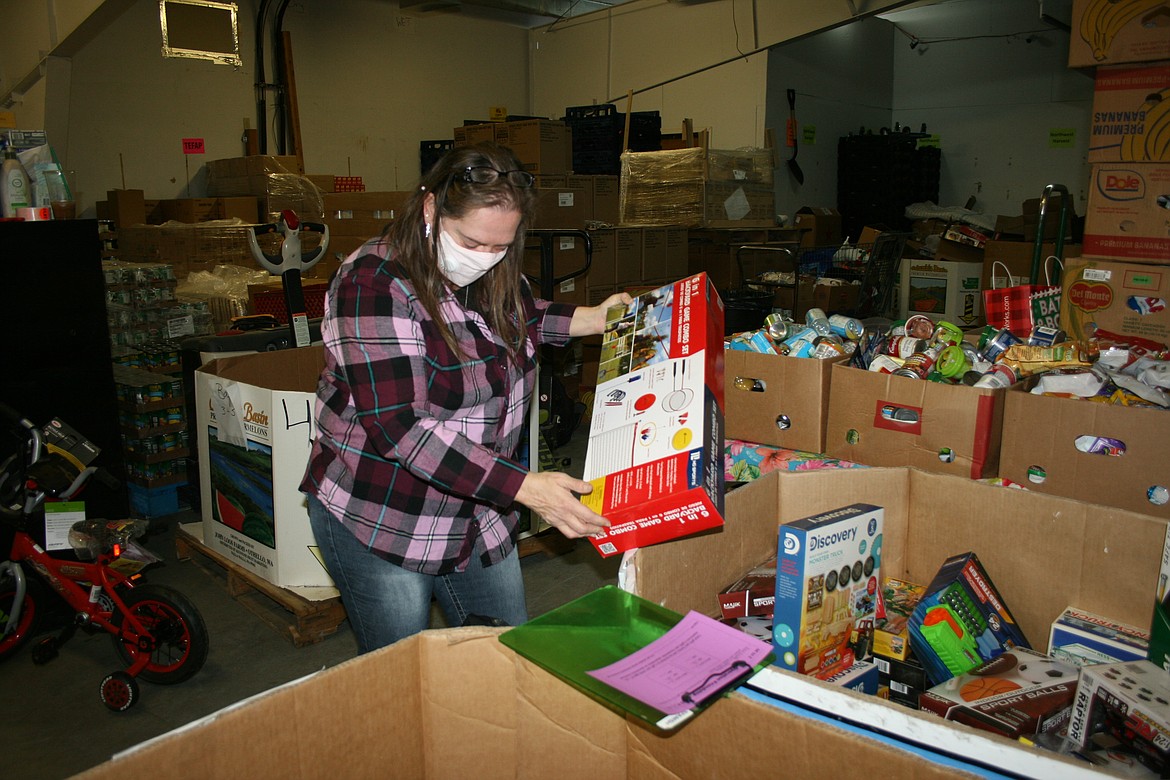 Kimberly Smith selects toys for a family during the 2020 Operation Friendship toy distribution at the Moses Lake Food Bank.