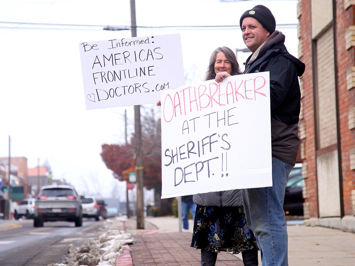 Two people stand in front of the Bonner County Courthouse on Monday, Nov. 22, to make a statement about the courthouse's mask policy implemented by the Idaho Supreme Court earlier this year.