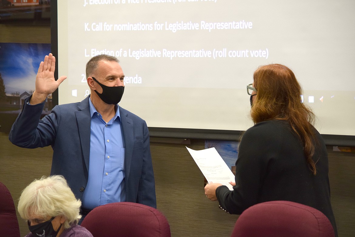 Interim Moses Lake School District Superintendent Carole Meyer swears in newly elected school board member Kevin Fuhr at a meeting Thursday.